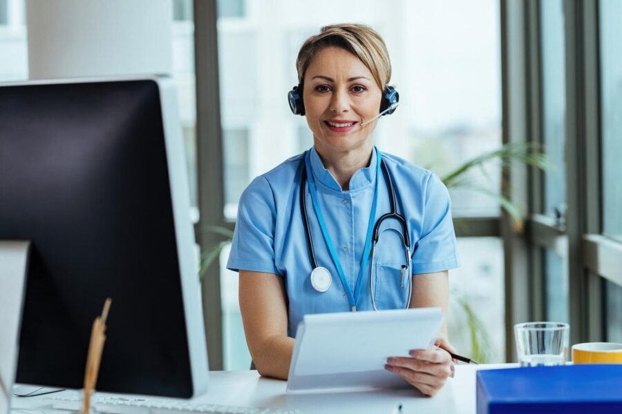 smiling-female-doctor-wearing-headset-while-working-medical-call-center-looking-camera_637285-5094